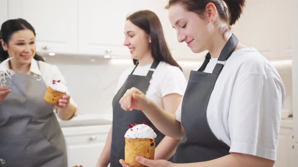 a Women Have Fun and Decorate Icing Dried Berries and Flowers Easter Cakes alt
