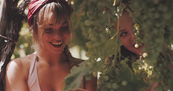 Two young girlfriends chatting and smiling alt