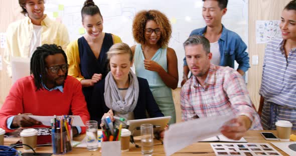 Business executives interacting with eachother during meeting alt