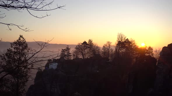 Pan of famous Bastei Bridge during sunrise in national park of saxon switzerland alt