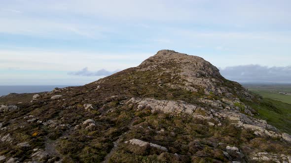 Carn Llidi rocky hill in Pembrokeshire, Wales. Aerial backward alt