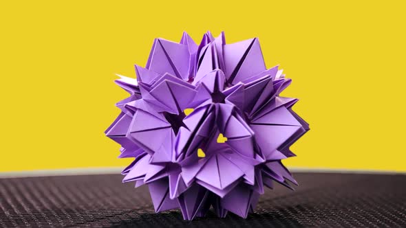 Beautiful Origami Flower on Yellow Background. alt