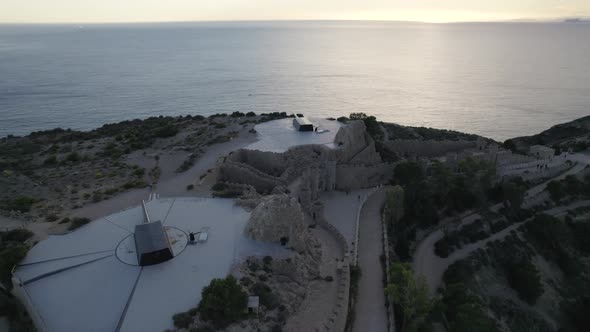 Castillitos battery guns overlooks Mediterranean Sea at sunset; aerial