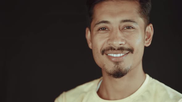 Portrait of young man smiling and feeling happiness alt