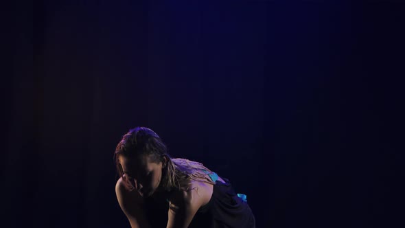 A Slender Blonde is Dancing Bachata Among the Raindrops and Splashing Water alt