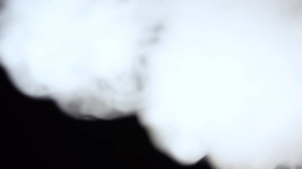 White Smoke Floating Through Space Against Black Background. Mist, Smoke , Vapor, Fog Effect. alt
