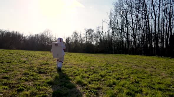 Spacewoman running over empty grassland