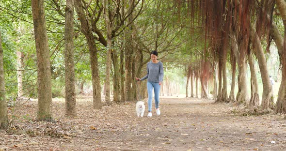 Woman run with dog in park alt