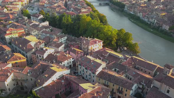 Aerial view of Verona City with bridges across Adige river. Medieval buildings with red tiled roofs alt