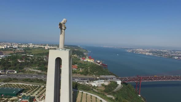 Aerial of Christ the King statue near 25th of April bridge