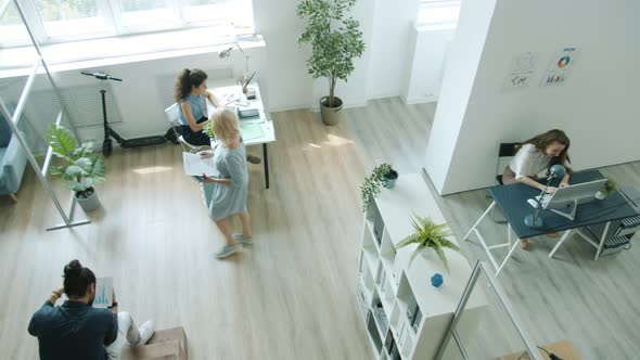 High Angle View of Employees Men and Women Working in Office Talking Walking Using Computers alt