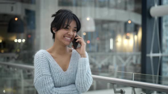 Middle Shot of Asian Female Laughing Talking on Phone While Walking