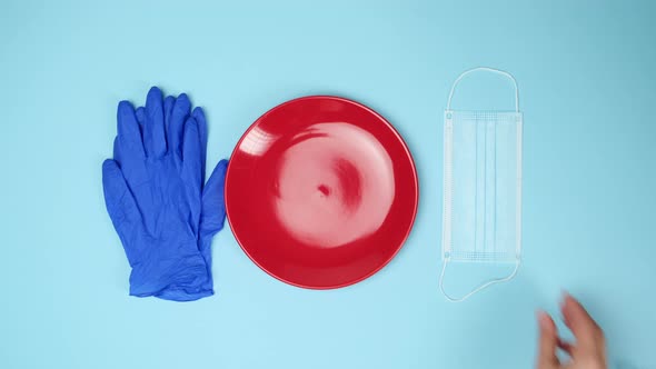 empty round red ceramic plate on blue background