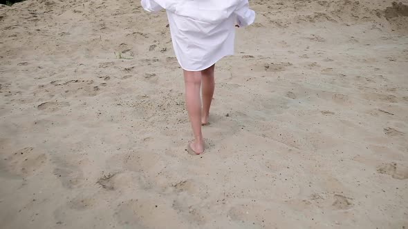 Follow Up Shot of Sexy Fit Seductive Woman with Long Hair Walking Up Sandy Hill alt