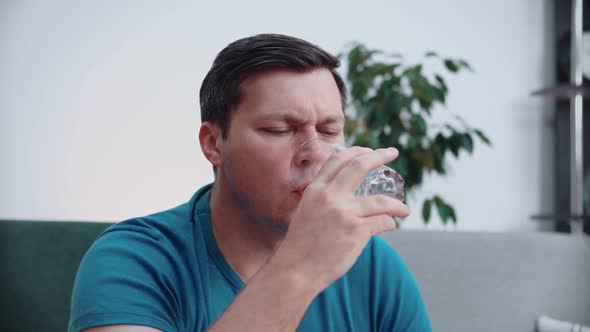 Portrait of a man drinking water from a glass