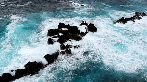 Top Down View of Big Waves Crashing Into Cliffs Near the Shores of Madeira Island Portugal