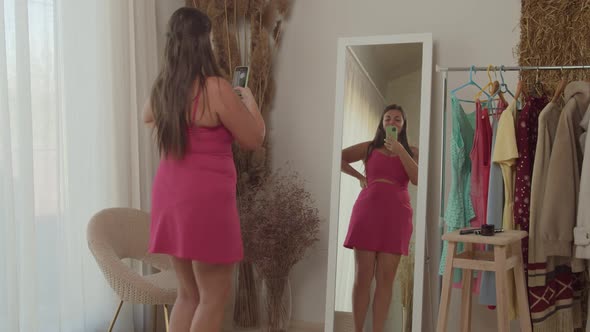 Plump Woman Live Broadcasting Over Internet Using Smartphone Indoors alt