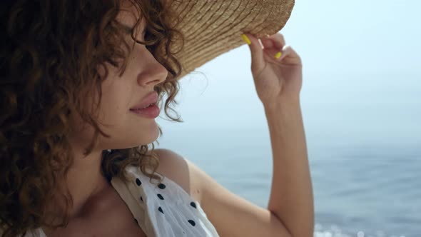 Portrait Luxurious Woman Wearing Straw Wide Brimmed Hat on Sunny Beach alt
