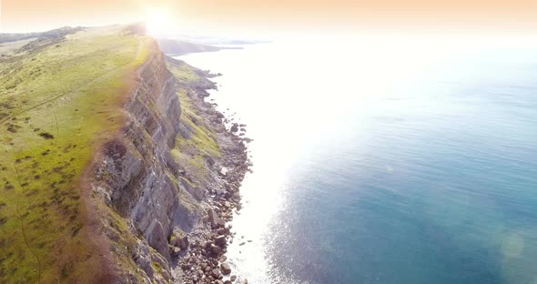 Sunrise Over a Large Coastline Cliff