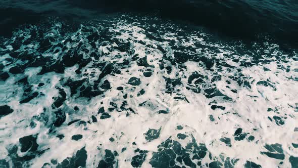 Top view of foamy sea surface with waves
