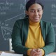 Slow Motion Portrait of African American Woman English Teacher Smiling in Classroom with Chalkboard - VideoHive Item for Sale