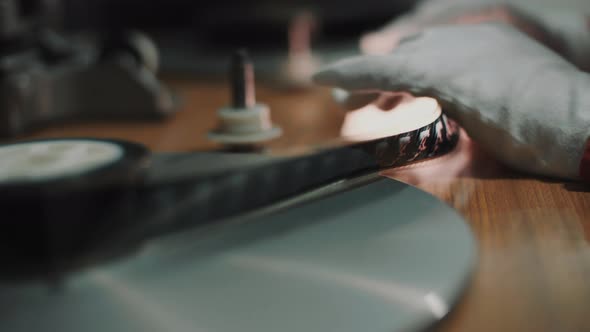 Detail of a film strip in the hands of a man alt