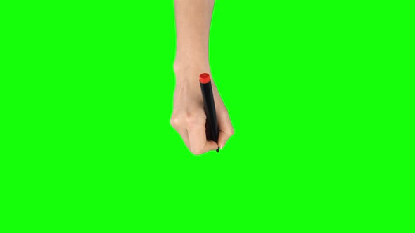 Female Hand with Red Marker Is Writing on Green Screen Background. Close Up alt