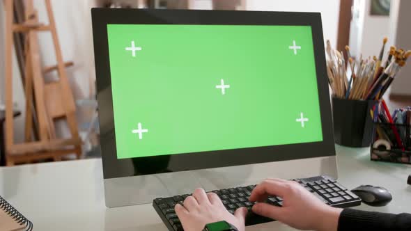 Male Hands Typing a Text on the Keyboard in Front of a Green Screen alt