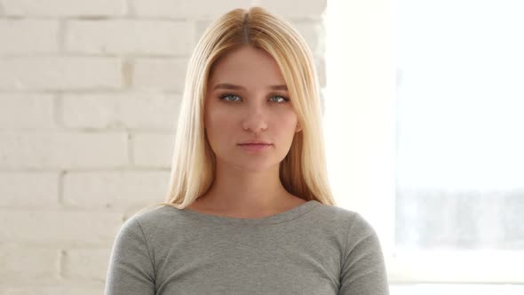 Woman Looking at Camera in Office alt