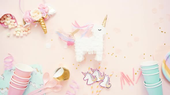 Birthday party in unicorn theme on pink flat lay. alt