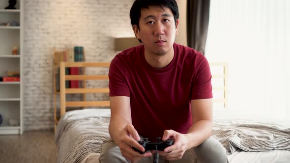 Young Man Holding a Controller Playing Video Console Game alt