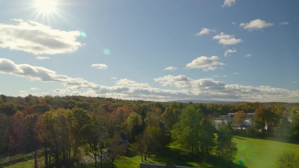 Lowering Aerial Shot from a Forest to a Vintage House and Barn alt