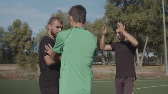 Soccer Team Arguing with Referee for Dismissal alt