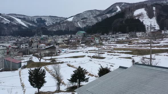 snow melting in nozawa onsen ski resort of nagano japan during winter, aerial alt