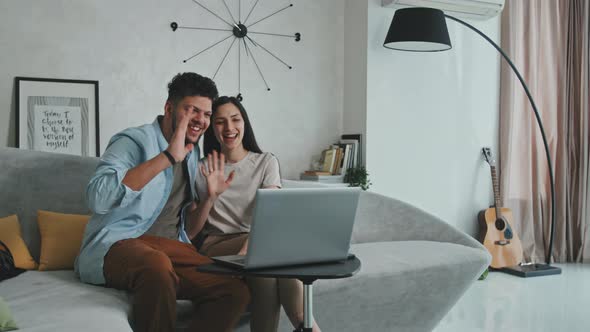 Happy Young Couple Having Video Chat On Laptop alt
