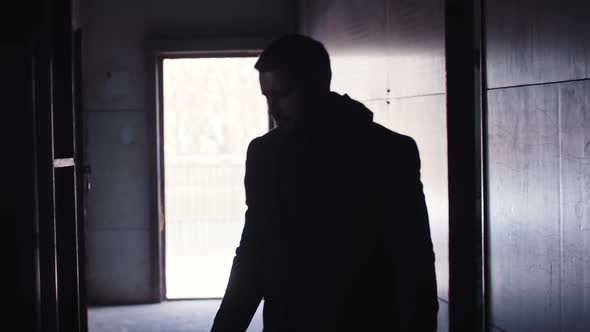 A Man Holds Two Pistols in His Hands and Blows Smoke From a Gunpoint alt