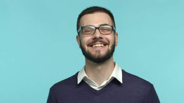 Slow Motion Portrait of Handsome European Man in Glasses Laughing and Smiling Happy at Camera