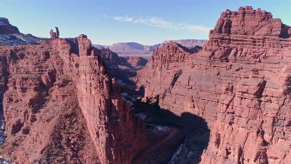 Flying over Onion Creek viewing the road and river cutting through the canyon alt