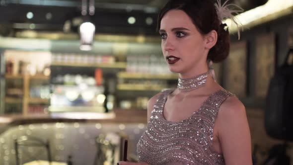 Closeup Portrait of a Young Attractive Woman in a 1920s Style at the Bar alt