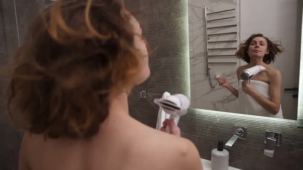 Joyful Beautiful Young Woman Drying Her Short Hair at in Bathroom Standing in Big White Towel alt