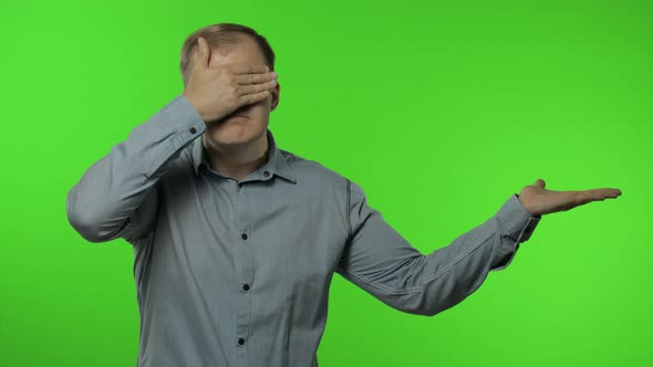 Man Showing Advertising Area. Looking Shocked, Pointing with Hands for Your Promotional Text, Logo alt