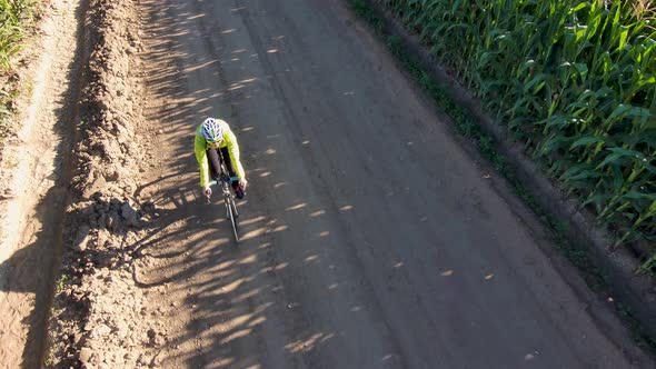 A dynamic orbital perspective shot of a cyclist on an early morning ride. alt