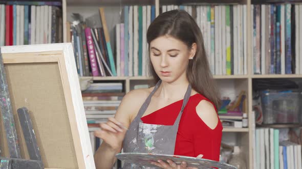 Charming Young Woman Painting at Art Workshop
