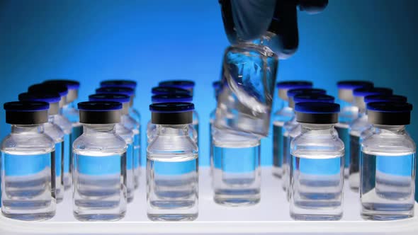 Group of Vaccine bottles. Medicine in ampoules. Glass vials for liquid samples in laboratory. alt