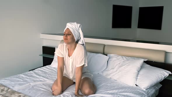 Portrait of a Young Woman with a Towel on Her Head After a Shower alt