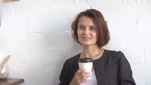 Young Attractive Businesswoman Drinking Coffee, Slow Motion.