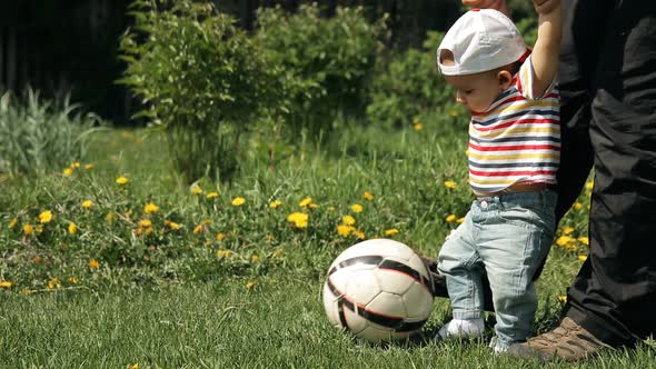 Slow Motion of Father and Child Playing Soccer