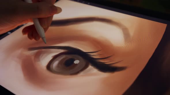 Close up of a digital pen drawing artwork on a graphic tablet alt