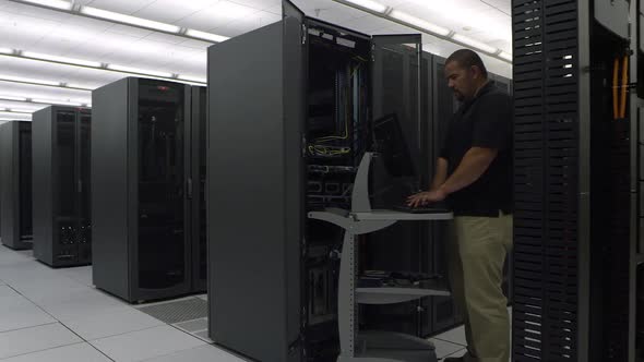 Reveling view of man working on network server alt