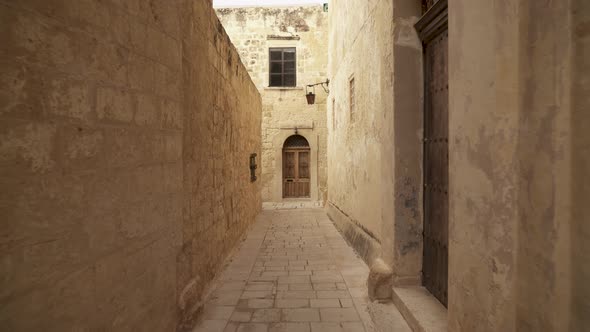 Narrow Street with Old Wooden Doors and Heavy Lantern Hanging on Building Wall alt
